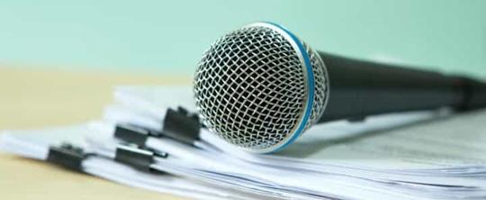 Microphone resting on papers