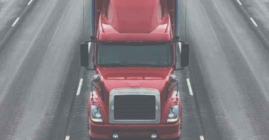 a truck driving down a multi-lane highway