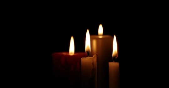 lit candles in a dark room