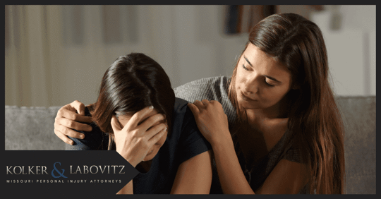 woman with her arm around a crying girl