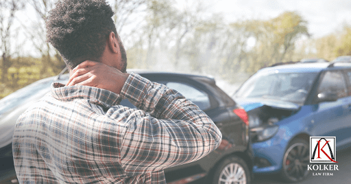 Guy holding neck after car accident